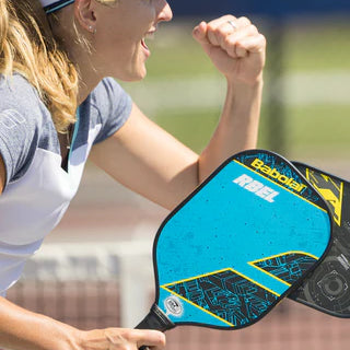 Racket Central woman playing pickleball with blue racket
