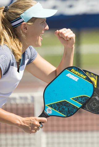 Racket Central woman playing pickleball with blue racket